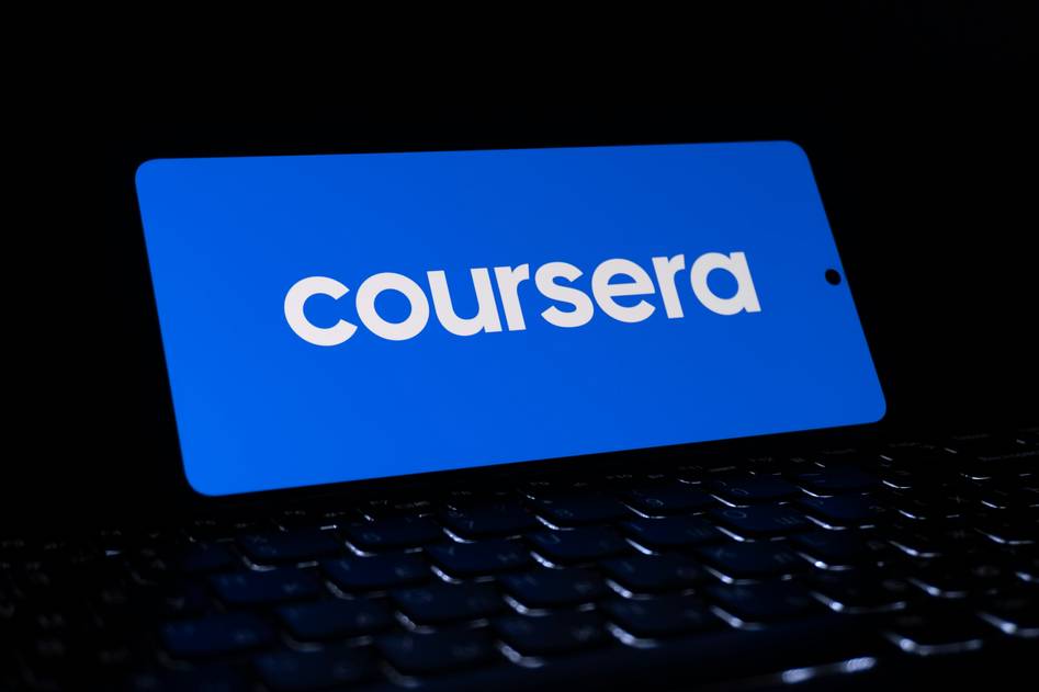 Blockchain developer coding on laptop with digital ledger graphics