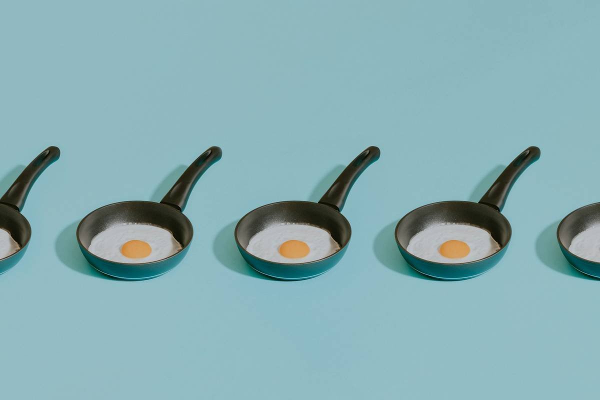 Side-by-side comparison of 4 types of egg poachers: silicone cups, stainless steel baskets, non-stick cups, and novelty plastic molds