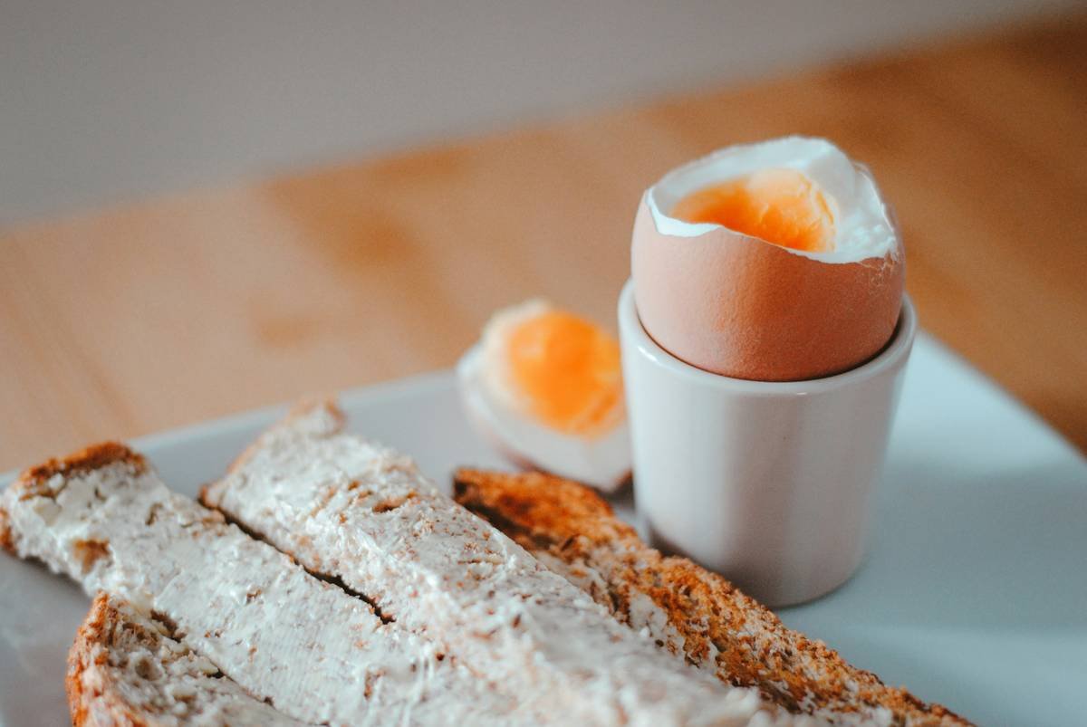 Close-up of stainless steel poaching accessory egg how to poach setup with simmering water