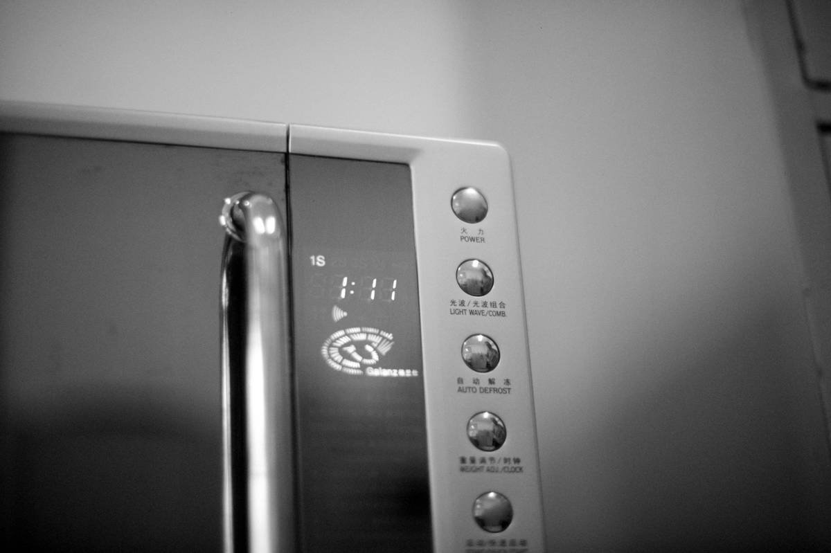 Close-up of a microwave egg poacher with water in the base and two eggs cooking, illustrating proper microwave egg poacher directions